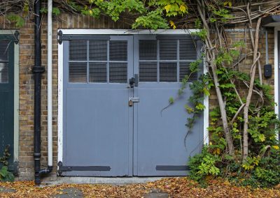 17036771 - old garage door with tree in london