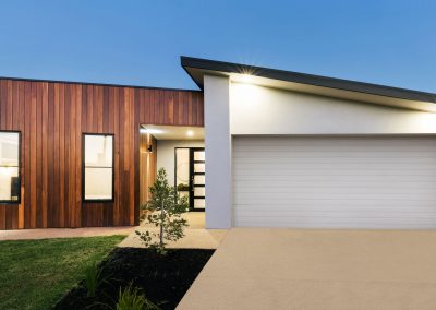 77027077 - contemporary new australian home lighting at dusk